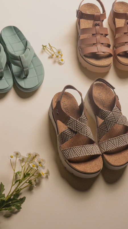 Kuru Footwear 2026 women's sandal collection featuring supportive fisherman-style platforms, comfortable thongs, and slides with built-in arch support in earthy tones.